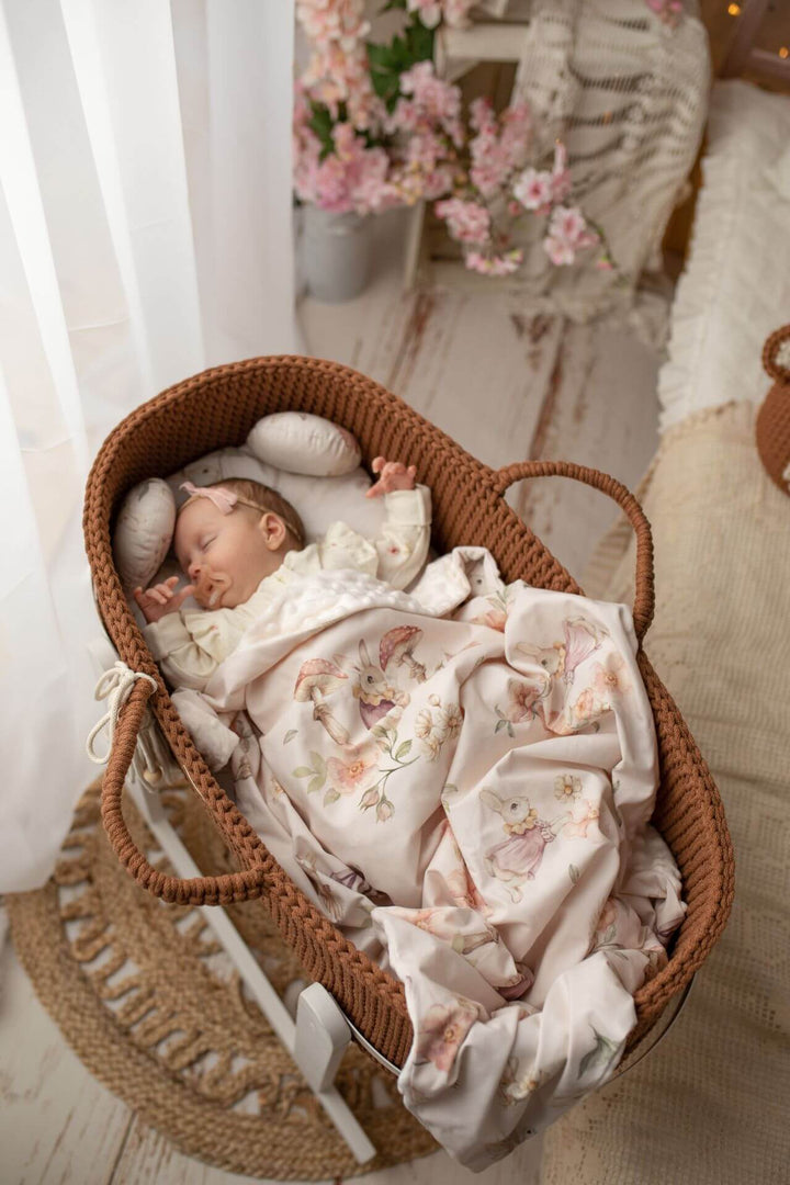 Baby in a chocolate brown handmade crochet moses basket