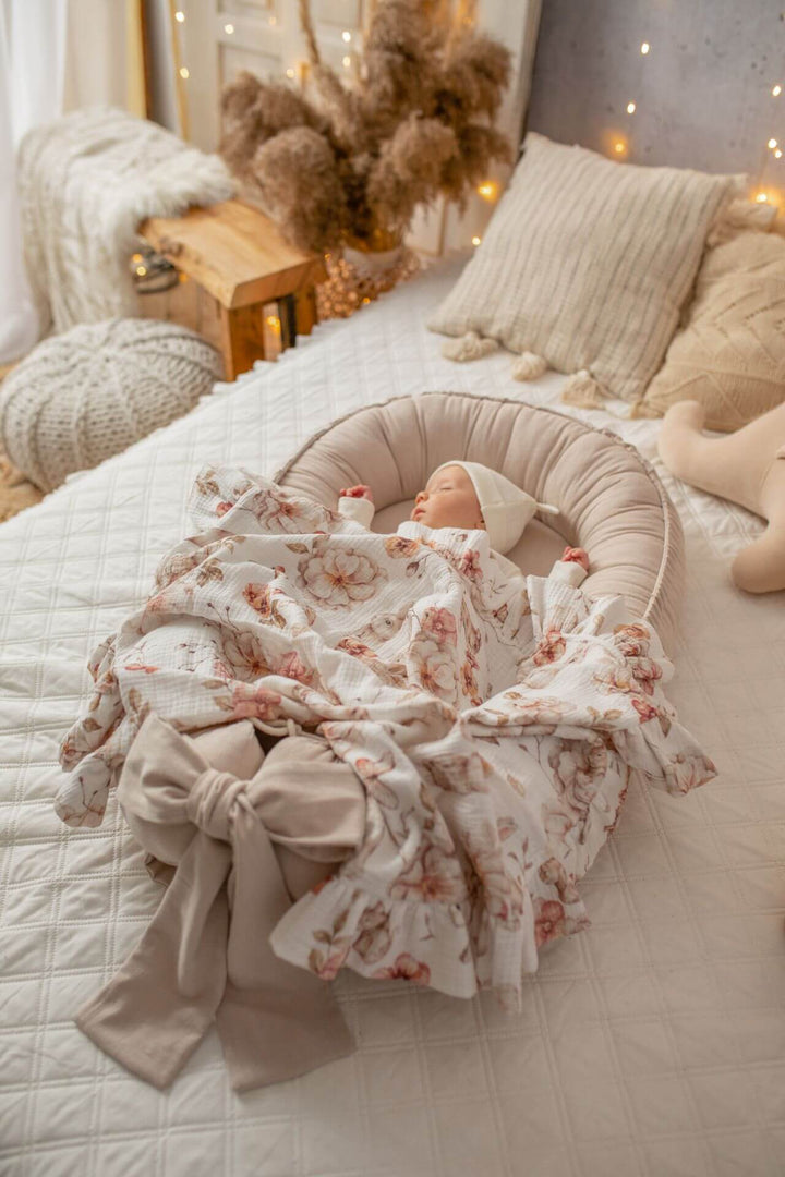 Baby in a beige baby nest