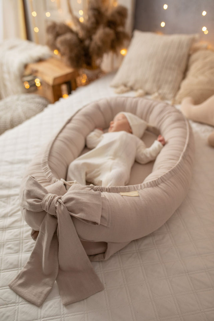 Baby in a linen baby nest