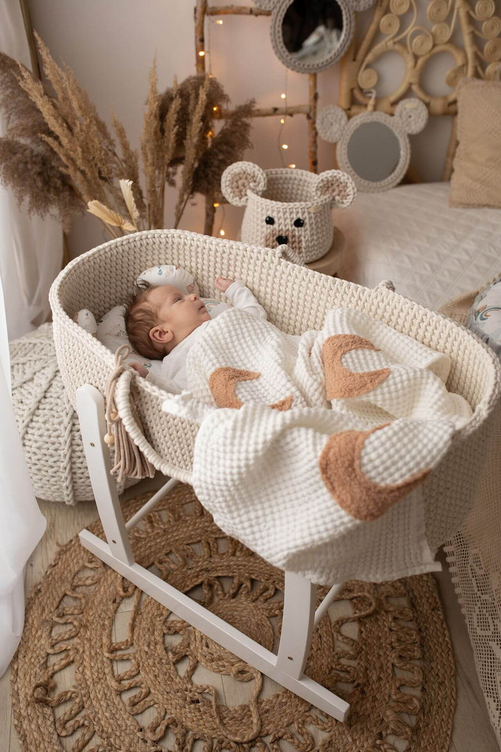 Cream handmade crochet moses basket with a baby boy