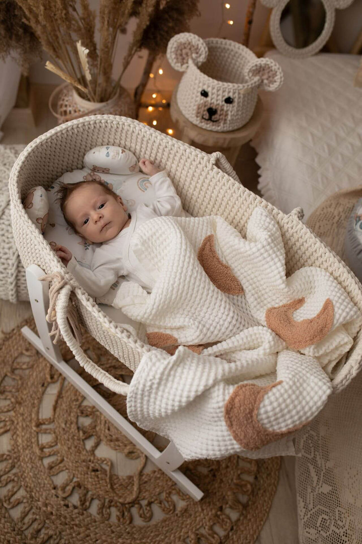 Baby in a cream handmade cotton moses basket